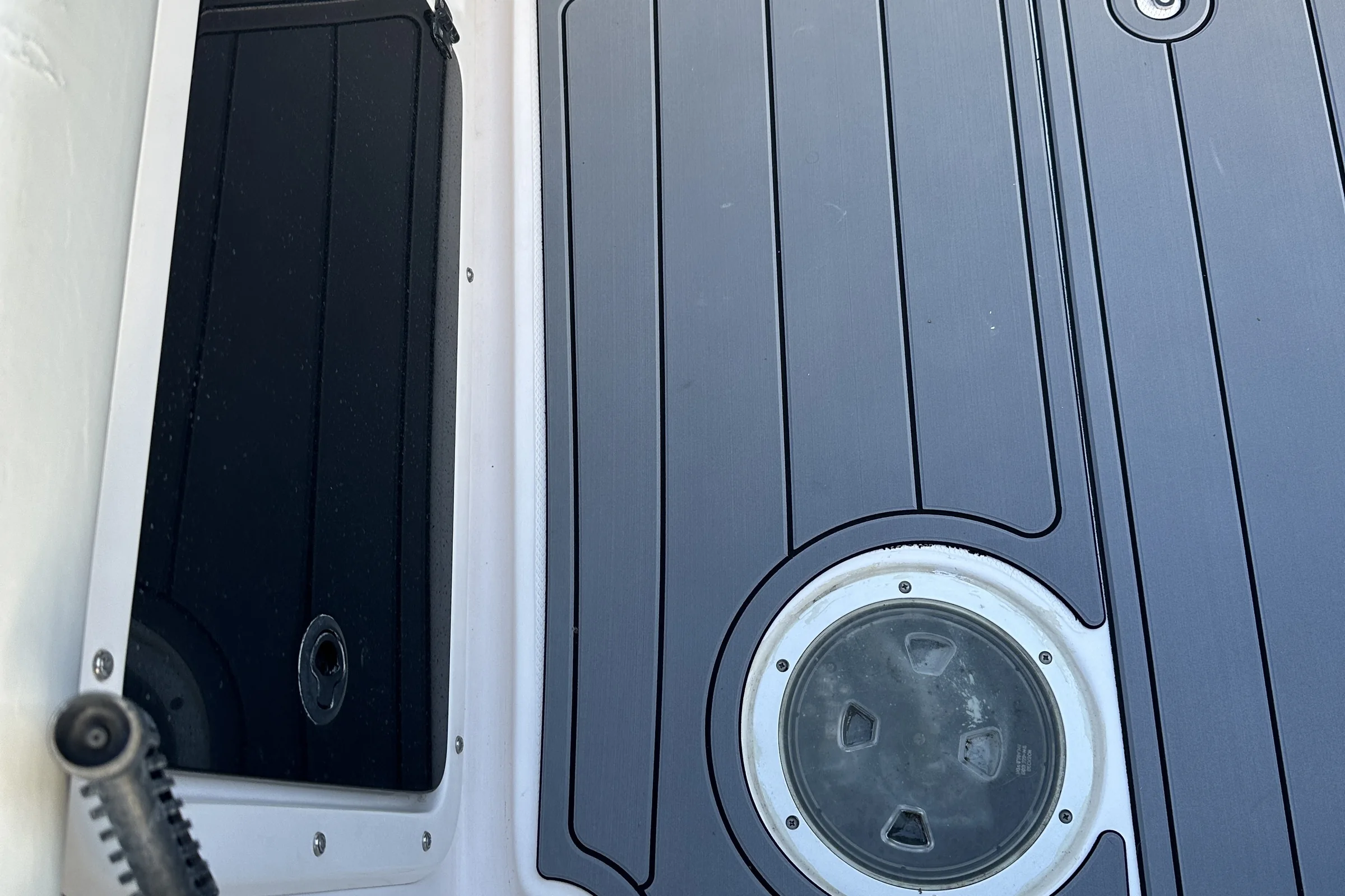 Grey EVA decking with black seams around a deck hatch