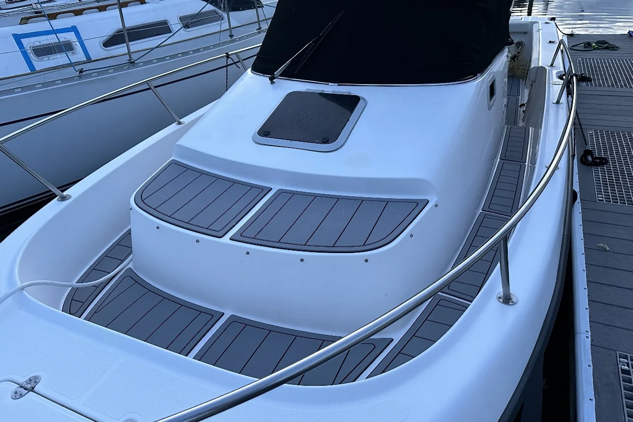 Grey EVA bow decking on a cruiser in the marina